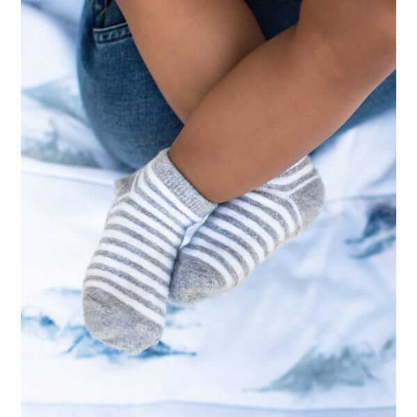 Striped Burts Bees Baby socks pictured on baby feet