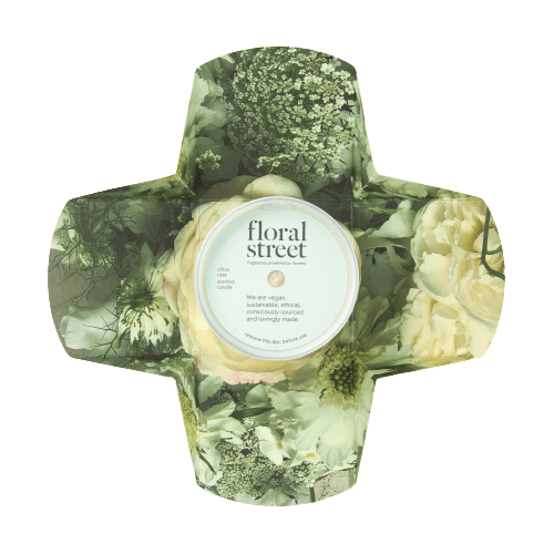 Floral Street pulp packaging featuring a candle in the center