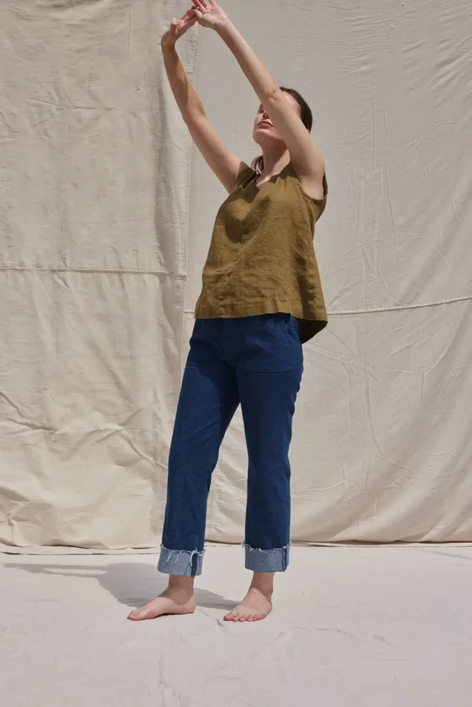 a women wearing navy denim and an olive green top