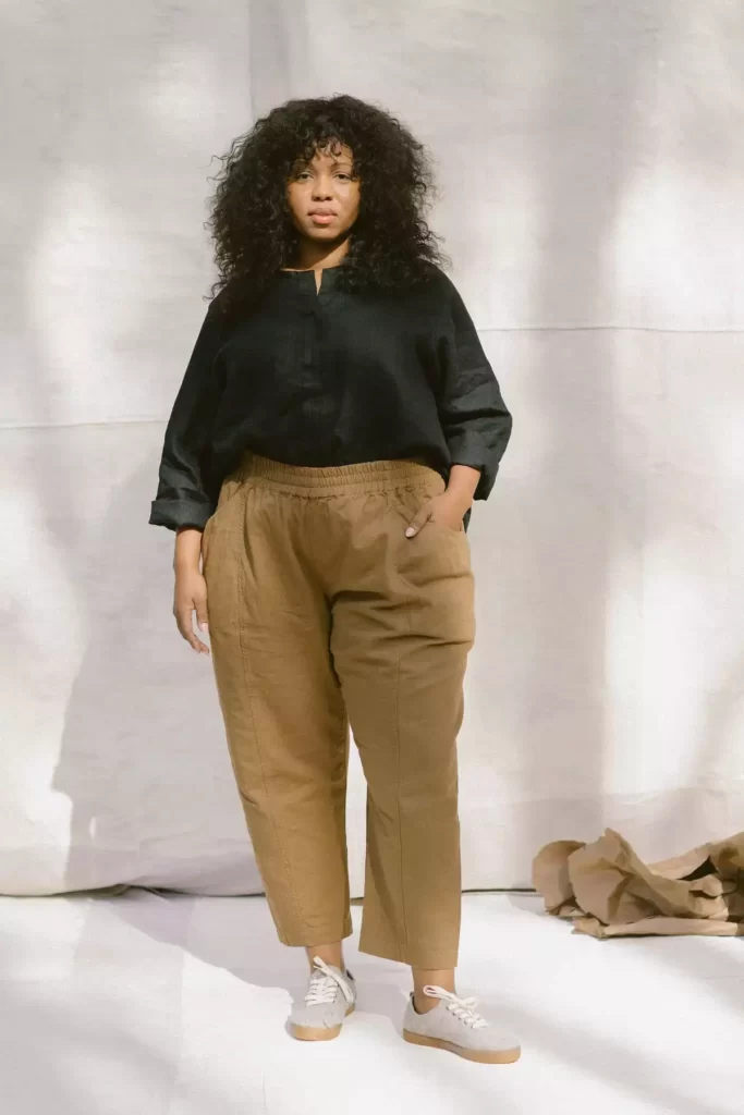 A woman wearing a dark top and khaki made in america trousers