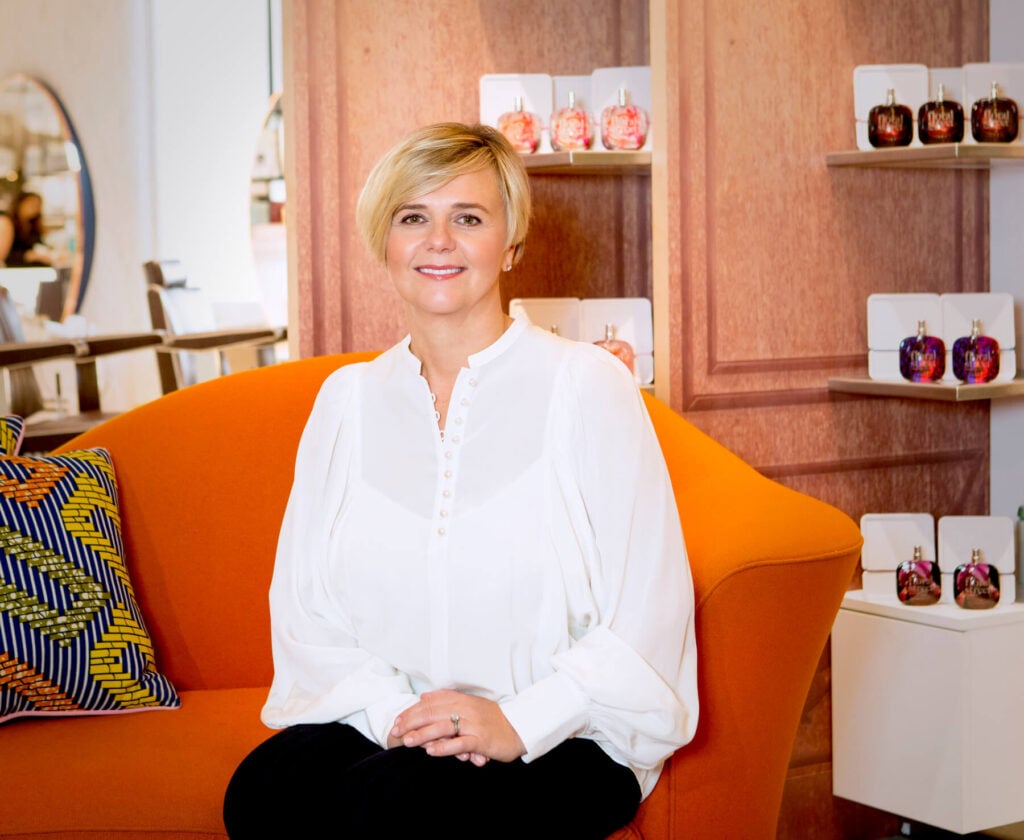 Michelle Feeney pictured with Floral Street perfume bottles